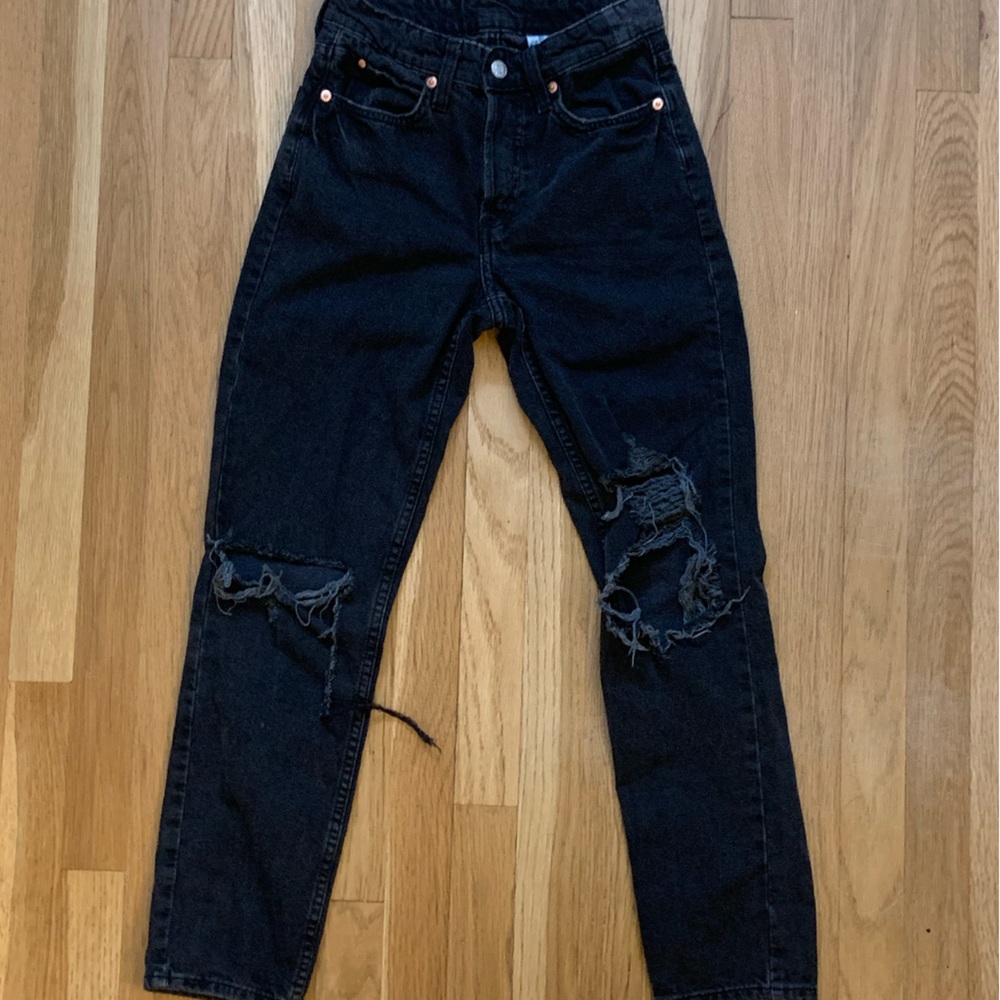 H&M straight leg black jeans with rips in the knees.